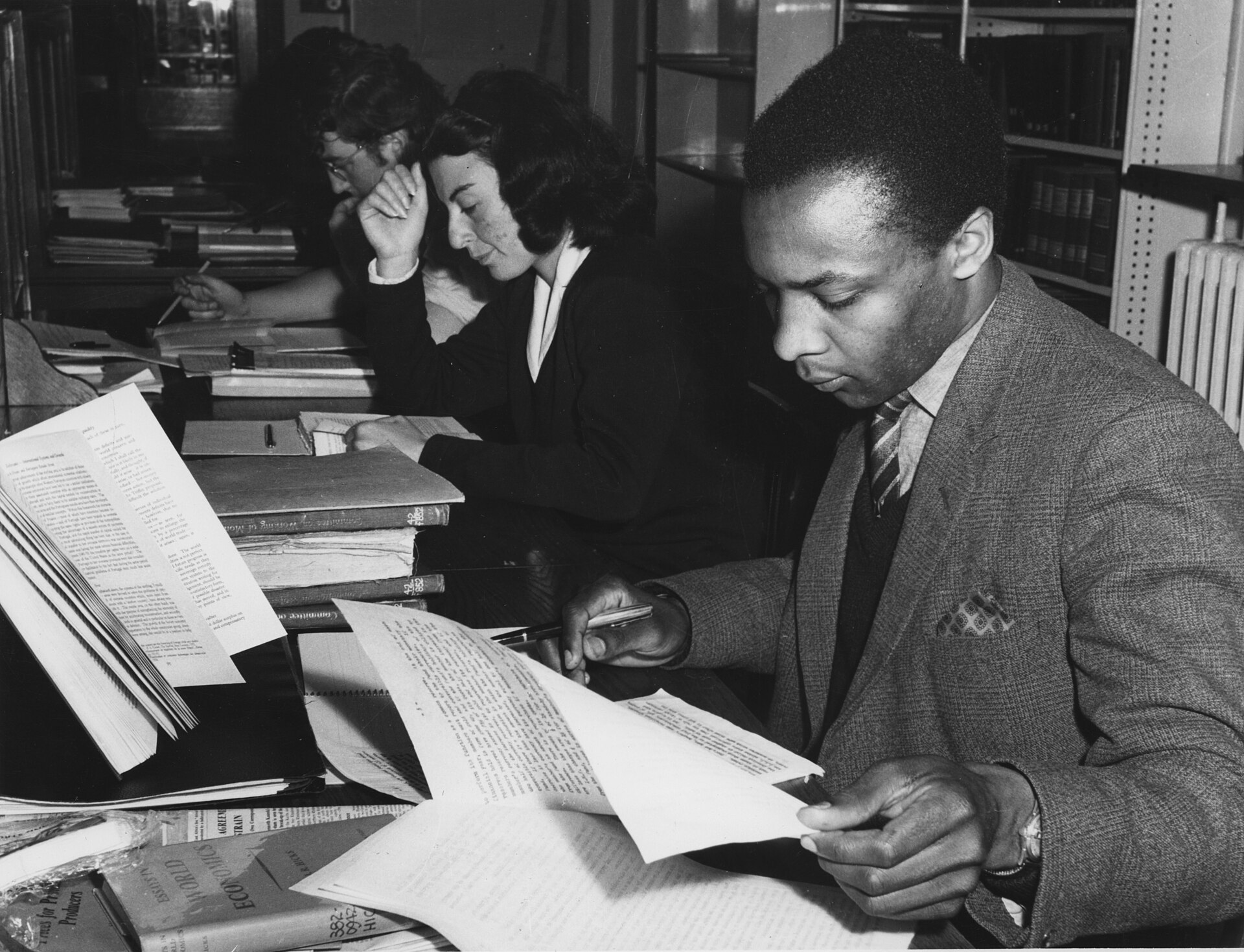 Readers studying at desks in an old library, 1964